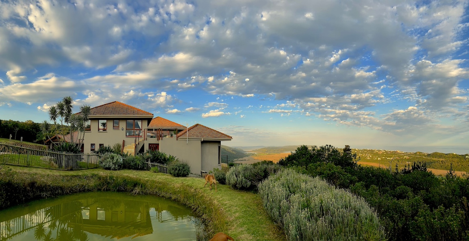 The Wilderland smallholding on its ridge above the dam, hills and distant sea
